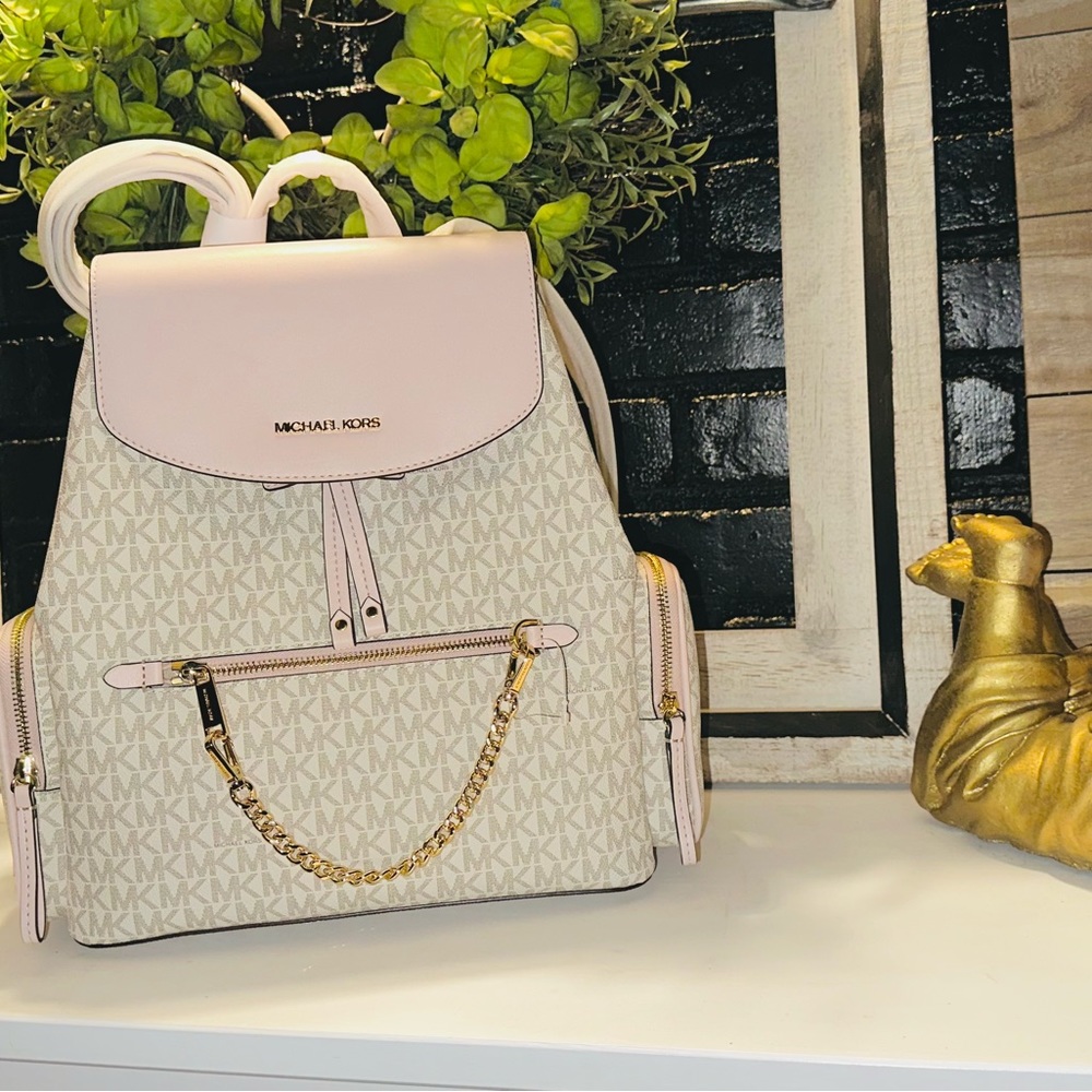 Micheal Kors pink and white backpack can be used as diaper bag
